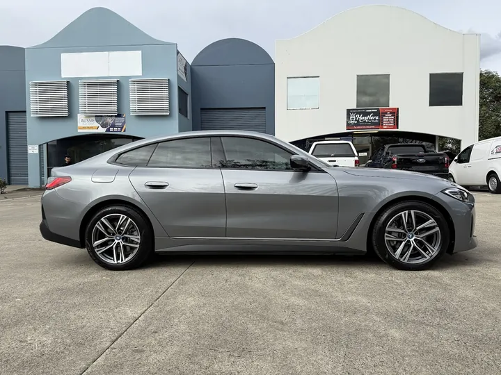Grey sedan parked side-on with evenly tinted side windows.