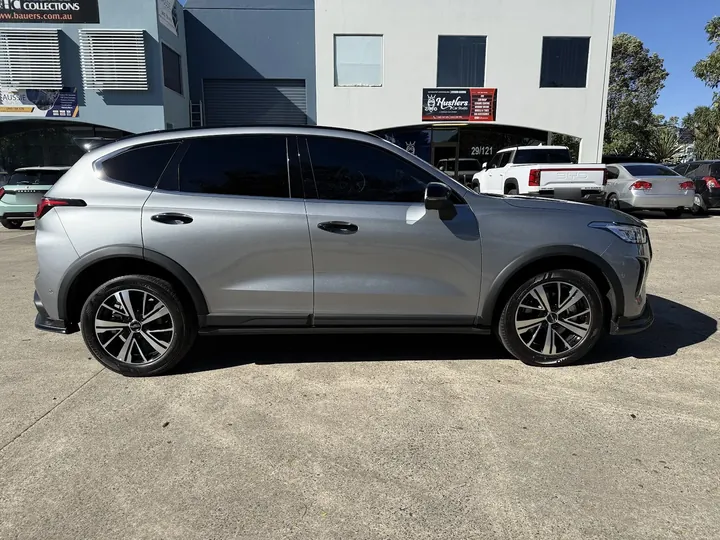 Silver SUV parked side-on with dark evenly tinted side and rear windows.